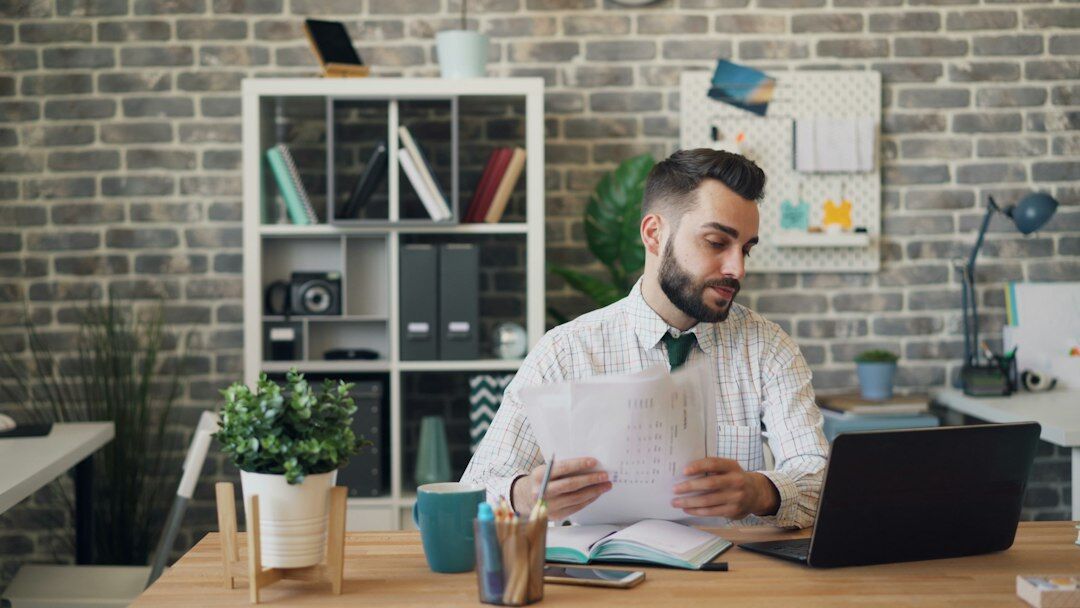 person reviewing documents at desk